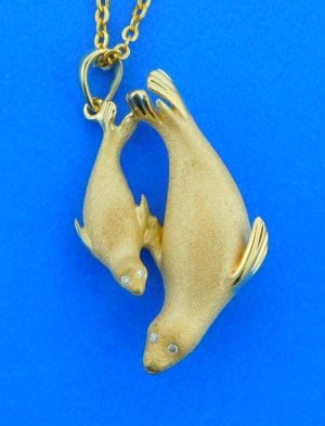 14k yellow gold mother & baby seal pendant, 3d, satin finish on the front, high polish on the back side, brilliant round diamond eyes .03ct twt 30mm long & 7mm thick