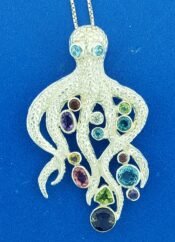 sterling silver octopus pendant with blue topaz eyes